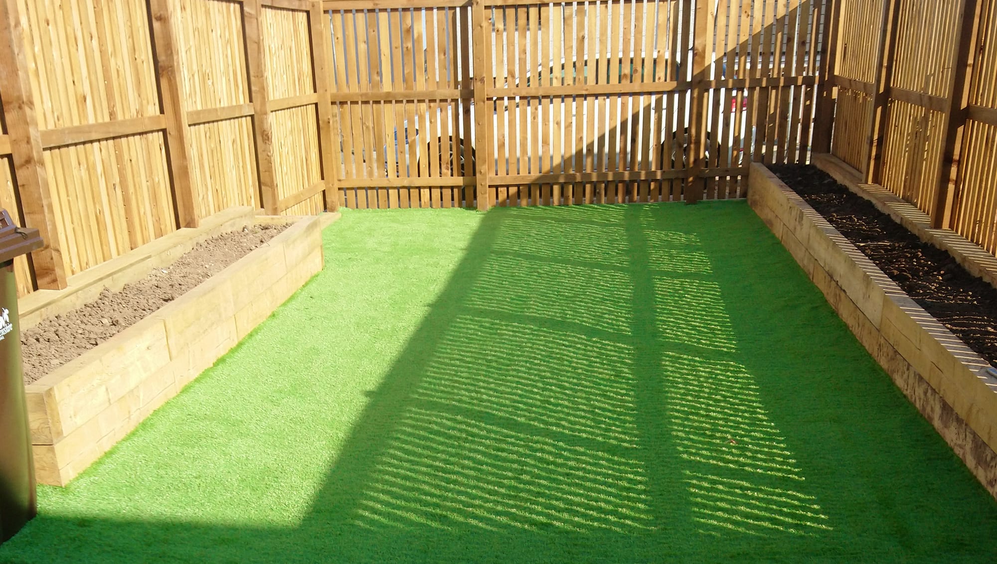 Wooden fence and wooden platers with artificial grass